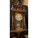 A 19thC wall clock with eagle pediment and white enamel dial. 80cms h.