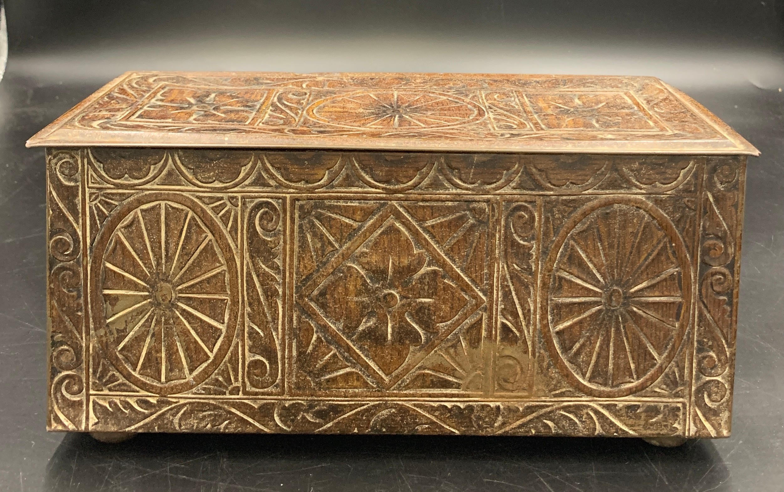 A vintage biscuit tin in the form of a carved oak coffer. 27 x 12 x 12cms h.Condition ReportGood