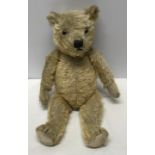 A plush fur Teddy Bear with glass eyes and stitched nose. 43cm h.Condition ReportDirt stained fur