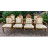 A set of 8 oak carver dining chairs with rattan backs and cushions and carving to crest rail.