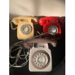Three vintage telephones, red, cream and brown.Condition ReportNot tested.