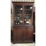 A mahogany bookcase cabinet with two door glazed panel. 215cms h x 114cms w at cornice x 47cms d.