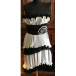 A Frank Usher black and white evening cocktail dress with ruffled layered sections and rosette to