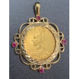 An 1890 full sovereign set in a 9ct gold mount set with four rubies. 13gms.Condition ReportGood