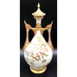 A Royal Worcester lidded vase with floral decoration and pierced dragon headed handles. 41cms.