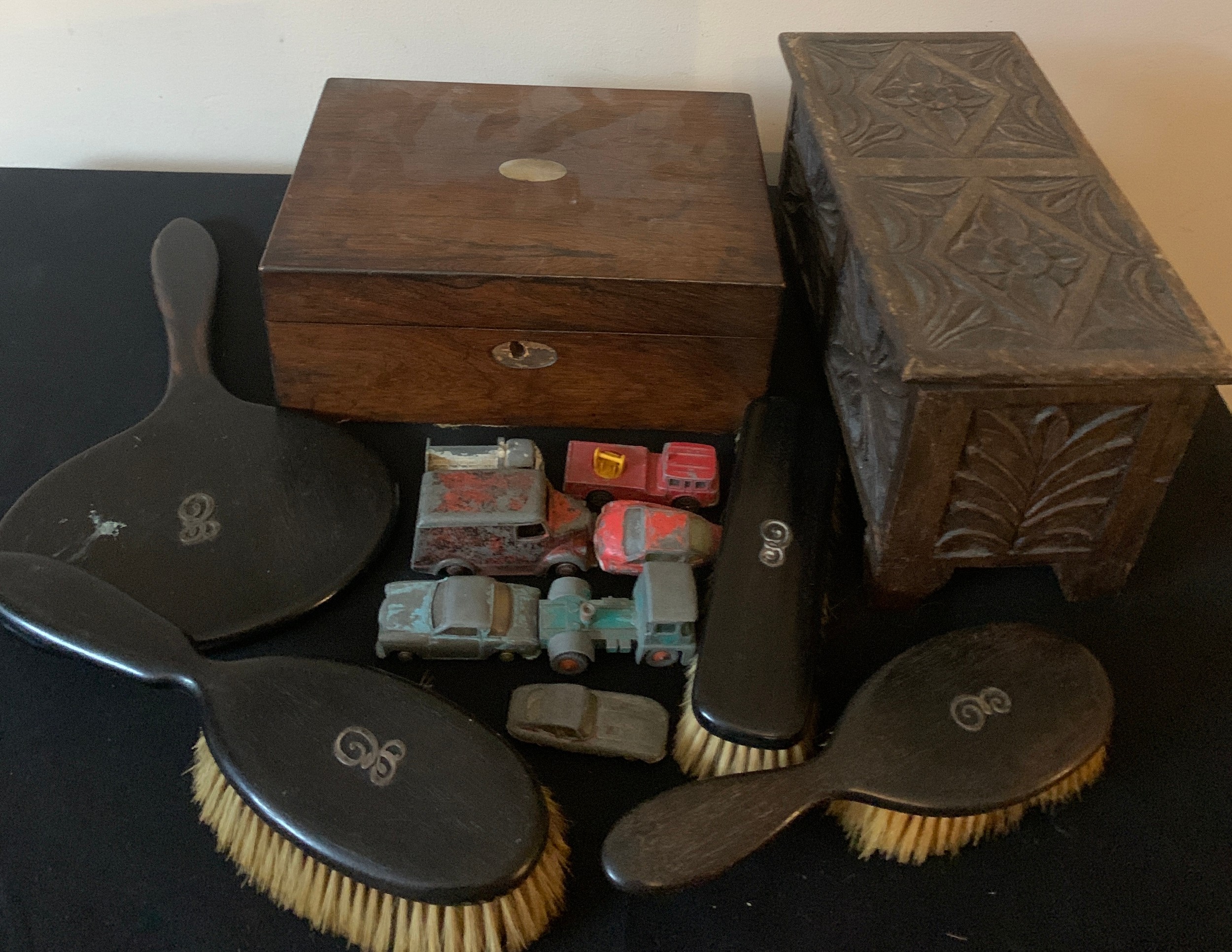 Miscellany to include ebony backed mirror and brushes, two wooden boxes and various toys to