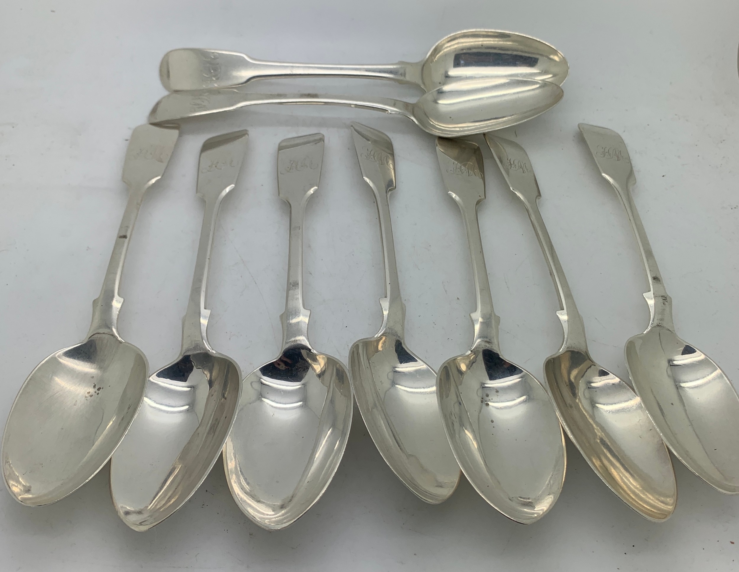 Nine silver dessert spoons. Seven London 1871 maker Henry Holland and two London 1805 maker