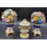 Three pieces of Bloor Derby porcelain to include a pair of floral urns 18cms together with a