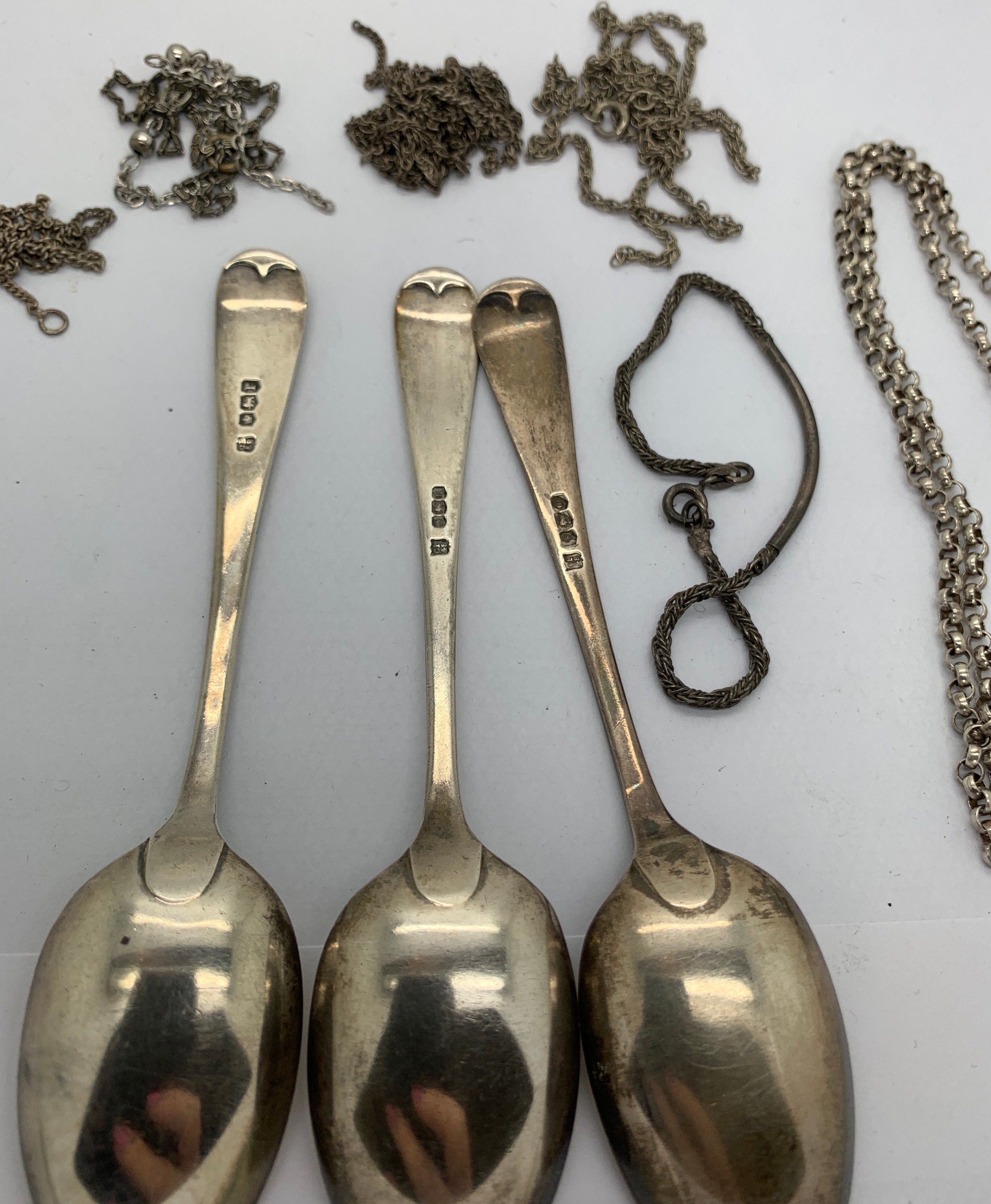 Three silver spoons and a quantity of silver and white metal chains. 78gms.Condition ReportChains - Image 2 of 2