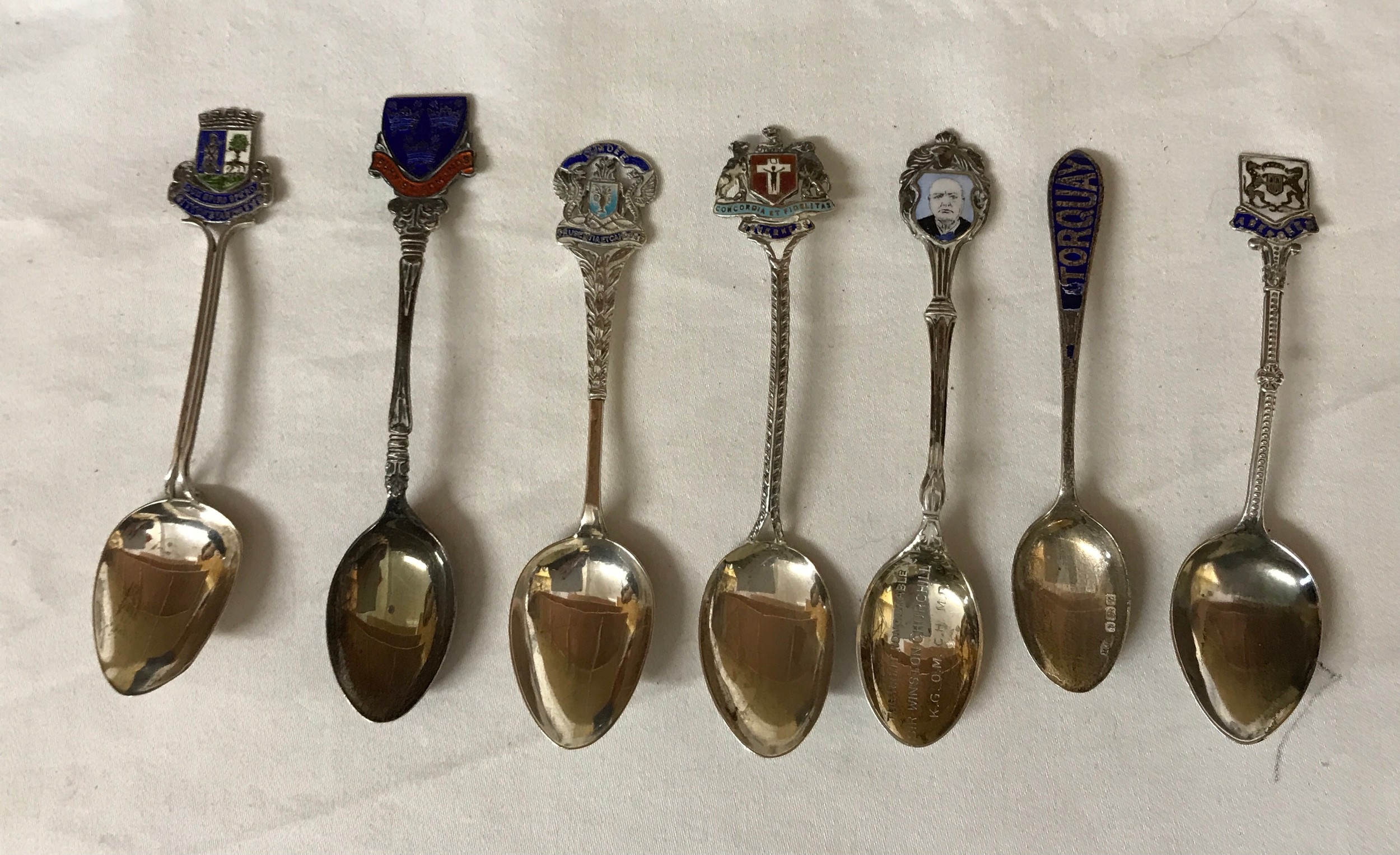 A collection of 7 souvenir silver spoons, 6 Birmingham and 1 Chester 1929. Enameled topped with UK