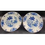 A pair of Dutch Delft pottery dishes of shallow form and decorated in blue Delft chinoiserie design.