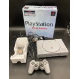 A Sony PlayStation Dual Shock console with controller, manual and original box.Condition ReportTears