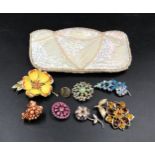 Pearls and sequin clutch bag with seven costume jewellery brooches.Condition ReportMinor staining to
