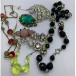 Vintage costume jewellery to include glass beads, necklaces, brooches and pendants.Condition