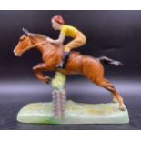 A Beswick figure of a girl on a jumping horse. Approx 25cms h x 27 x 8cms at base.Condition