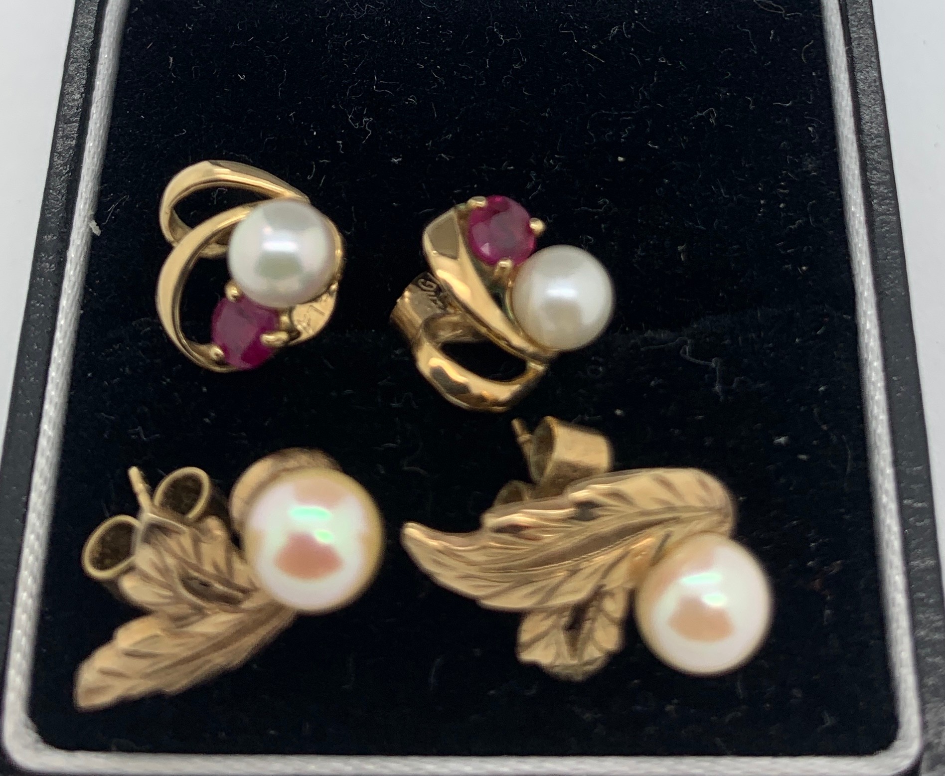 Two pairs of 9ct gold earrings set with pearls and rubies.Condition ReportGood condition.