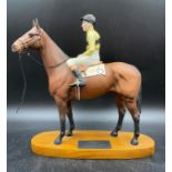 A Beswick figure of the racehorse Arkle, with Jockey Pat Taaffe up, on oval wooden plinth base,