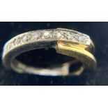 An 18ct white and yellow gold ring set with 8 diamonds. Size M, 6.2gms.Condition ReportGood