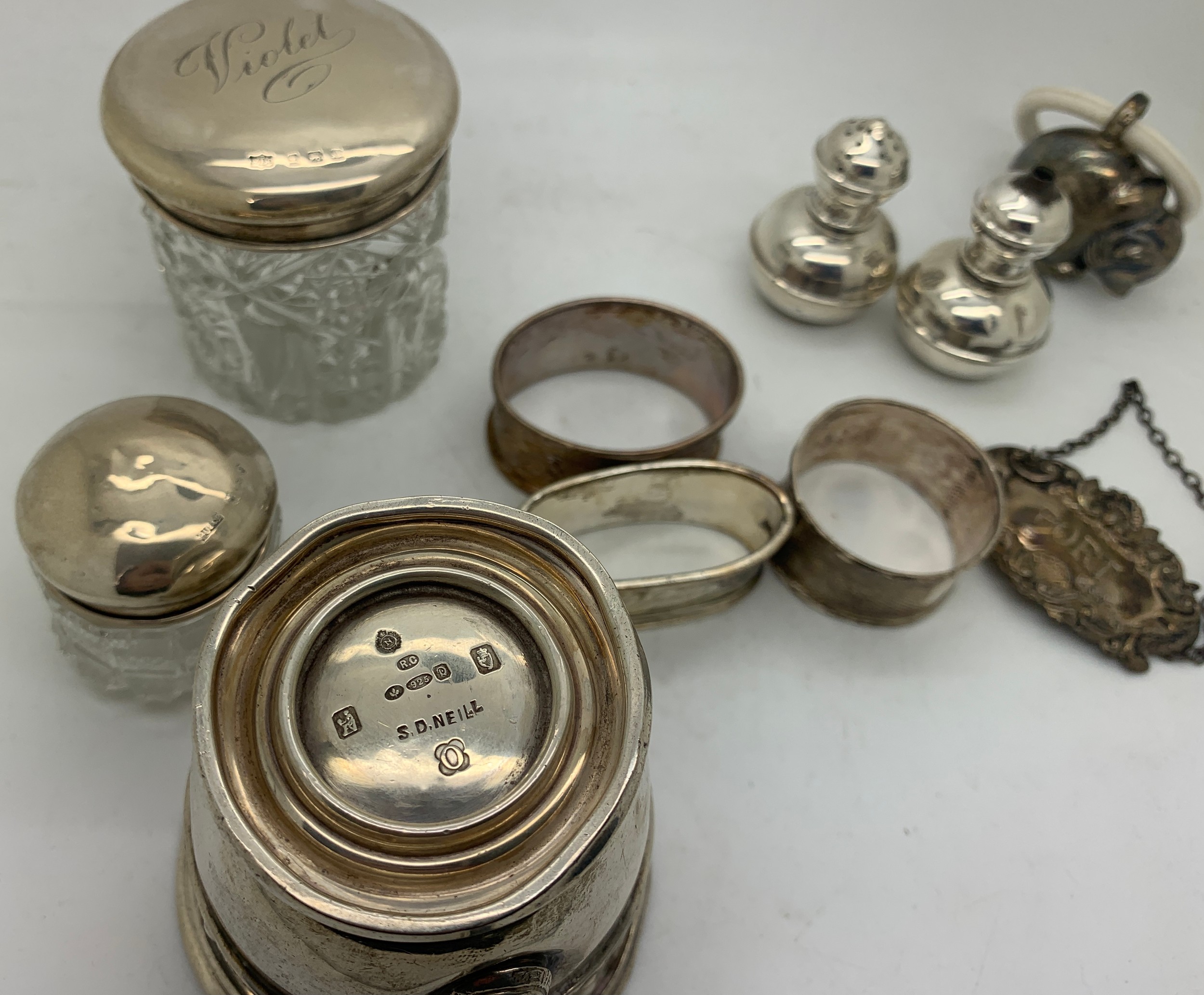 Hallmarked silver items and a child's rattle marked .800 to include napkin rings, Port label, mug - Image 3 of 3