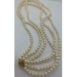A three strand cultured pearl necklace with clasp marked 14k. Approx. 46cms l.Condition ReportGood