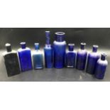A collection of nine blue glass bottles, rectangular and circular, tallest 20cms h, smallest 12cms