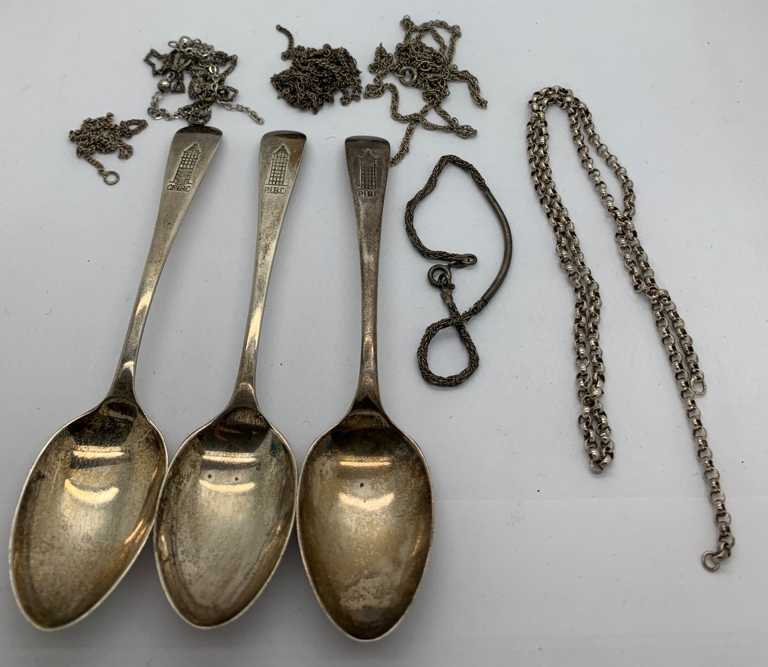 Three silver spoons and a quantity of silver and white metal chains. 78gms.Condition ReportChains