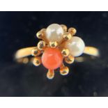 A seed pearl and coral ring set in 9ct yellow gold. Size N. With matching earrings. Total weight 4.