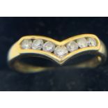 An 18ct yellow gold ring set with 7 diamonds in a V formation. Size P/Q, weight 2.9gms.