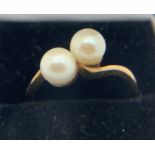 A 9ct yellow gold ring set with two cultured pearls. Size M. Weight 2.6gms.Condition ReportGood