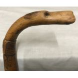 A walking stick with carved wood hounds head handle with glass eyes and silver collar, Birmingham