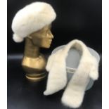 A mink beret style hat with silk tail and bobbles by Mitzi Lorenz of London with a matching mink