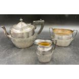 A hallmarked silver three piece tea set with half reeded body by James Dixon & Sons, Sheffield.