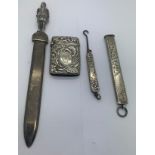 Four various silver and white metal items to include a paperknife, a button hook Birmingham 1901,