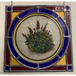 A pair of well made leaded glass window panels, both with centre panels of flowers in multi colours.