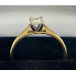 A princess cut solitaire diamond ring set in yellow metal (marks rubbed), size O, weight 2.7gms.