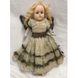 A 19thC wax headed doll with original angel dress. 34cms h.Condition ReportCracked, repaired head,