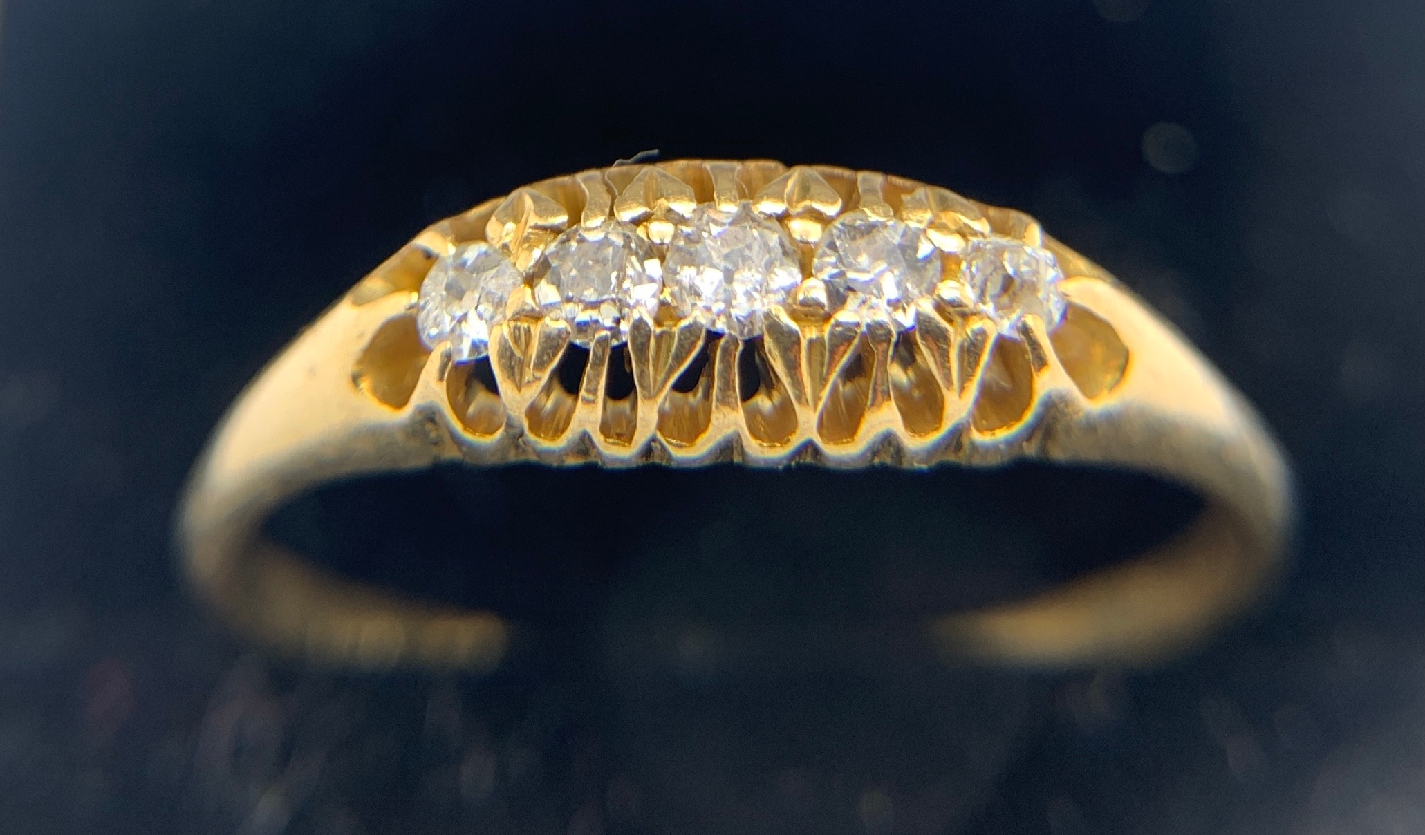 An 18ct gold ring set with 5 diamonds. Size W. weight 3gms.Condition ReportGood condition.