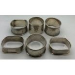 Six silver napkin rings. Various dates and makers. Three with inscriptions. Total weight 155gms.