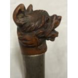 A walking stick with carved wood terrier dogs head with glass eyes and white metal collar, 89cms l.