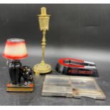 A vintage Evanus fuel flinted cat and shade table lighter together with two other lighters and a