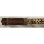 A walking cane of a sharks vertebrae with a leather handle, 83cms l.Condition ReportTwo sections