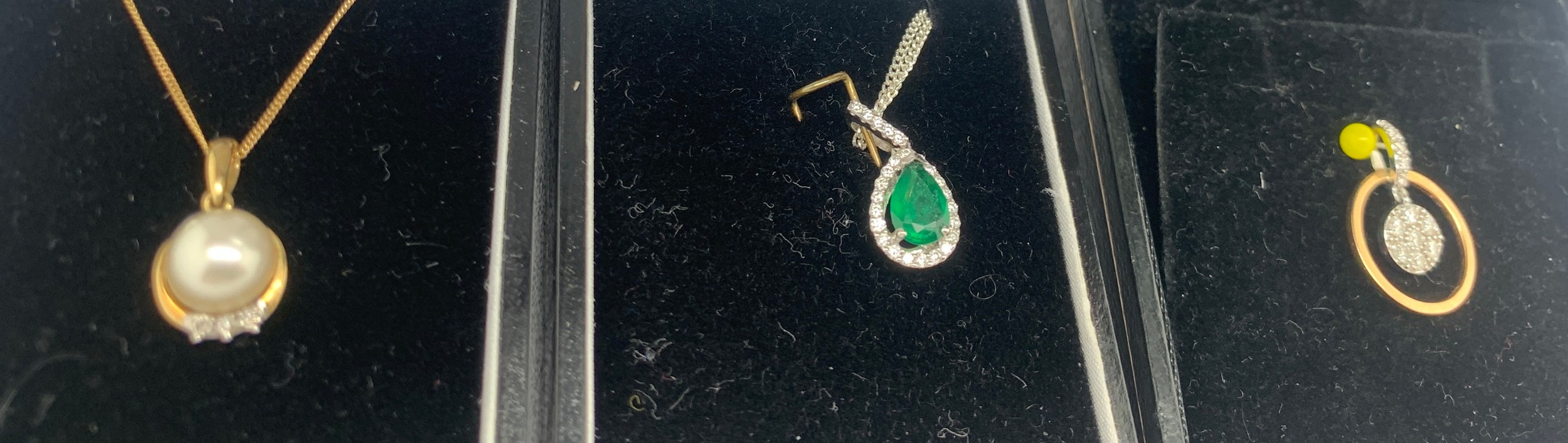 Three gem set pendants, one 18ct white and yellow gold set with diamonds, 18ct white gold emerald