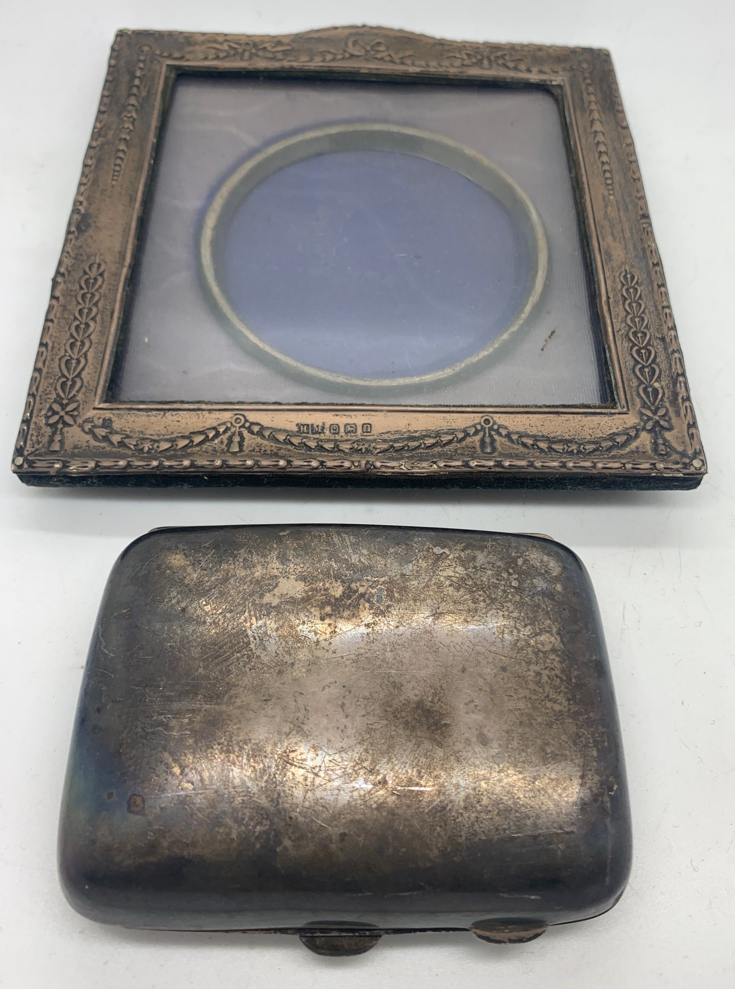 A silver photograph frame Birmingham 1912 by H. Matthews together with a cigar case Birmingham