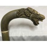 A full sectional horn and bone walking stick with carved dragon head handle, 91cms l.Condition