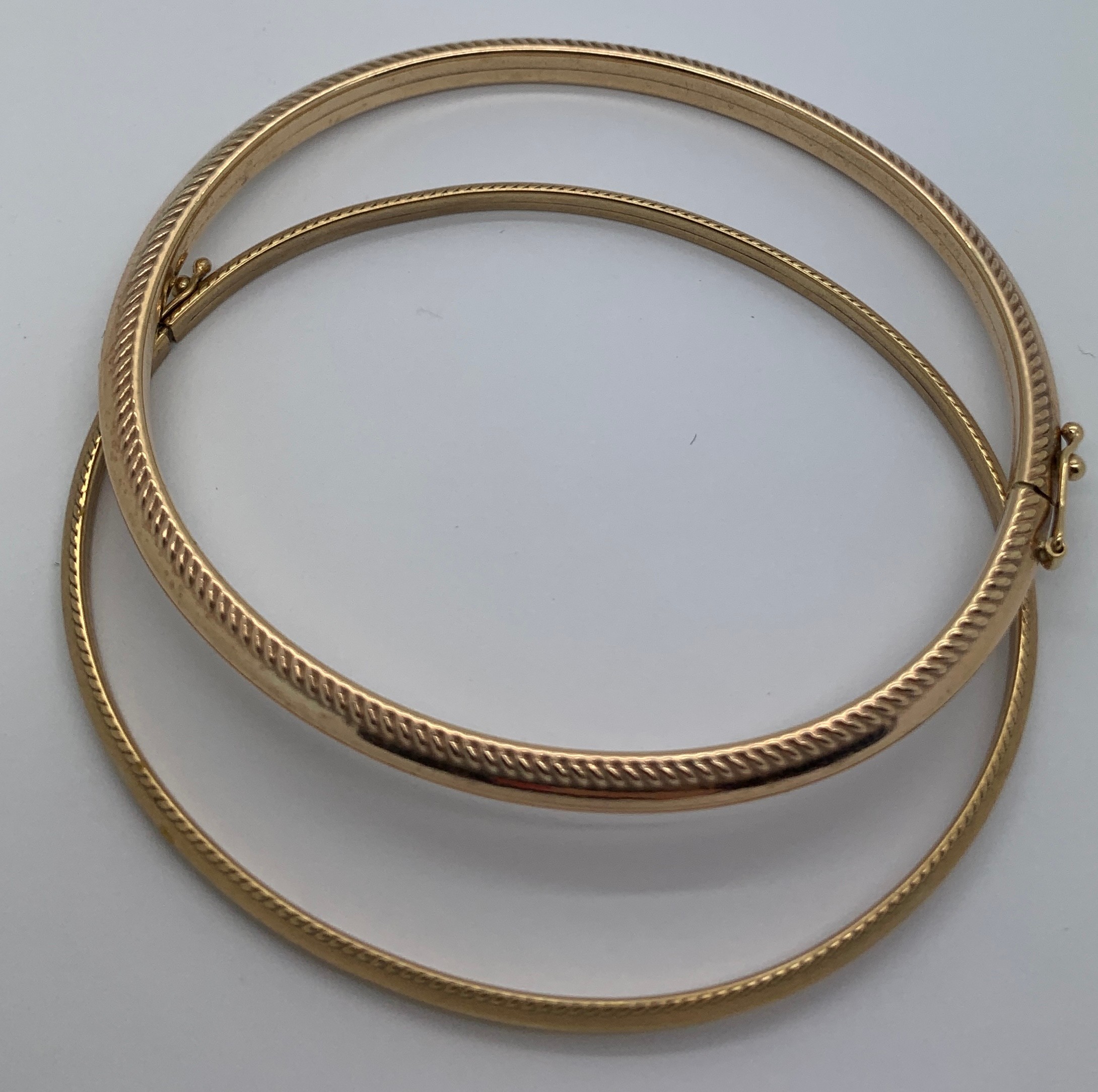 Two 9ct gold bangles. 7.1gms total. 6.1 and 6.3 widest internal measurements.Condition ReportGood