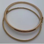 Two 9ct gold bangles. 7.1gms total. 6.1 and 6.3 widest internal measurements.Condition ReportGood