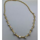 An 18ct gold diamond set collar "V" shaped necklace set with 15 diamonds.