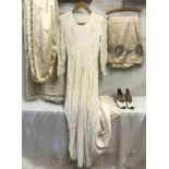 A collection of vintage wedding items to include a heavy cream silk train with glass beads and