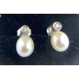 Pearl and diamond earrings set in 18ct white gold. 2.3gms.Condition ReportGood condition.