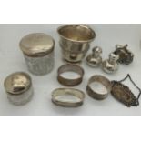 Hallmarked silver items and a child's rattle marked .800 to include napkin rings, Port label, mug